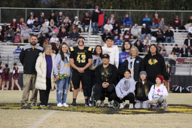Tecumseh Head Football Coach Ty Bullock poses with Braylen Walker and his family during Senior Night ceremonies on Nov. 3. There were 14 football seniors and three managers honored that evening, as well as band and cheer seniors. Countywide &amp; Sun/Natasha Dunagan