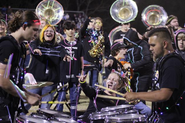 Tecumseh drummer Laycee Thoma cheers on fellow drummers Dalton Lewelling and Alan Lopez-Moreno, along with the rest of the band, following the annual light show at halftime of the Nov. 3 home game. Countywide &amp; Sun/Natasha Dunagan
