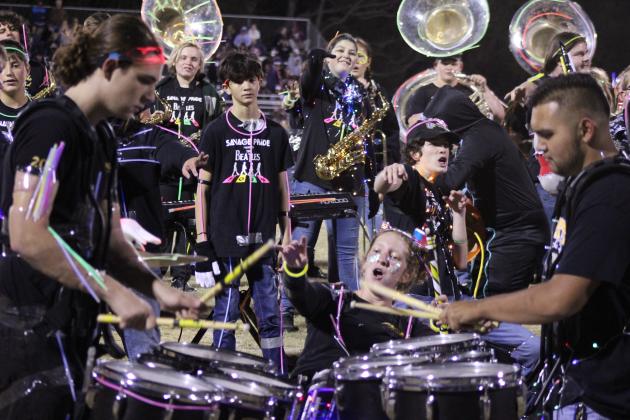 Tecumseh drummer Laycee Thoma cheers on fellow drummers Dalton Lewelling and Alan Lopez-Moreno, along with the rest of the band, following the annual light show at halftime of the Nov. 3 home game. Countywide &amp; Sun/Natasha Dunagan
