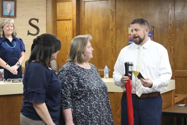 Dr. Aaron Espolt, Shawnee superintendent, far right, presents the Star of the Month award to Natalie Jackson, middle, as Shawnee Early Childhood Center Principal Karen Watkins looks on during the Nov. 6 Shawnee Board of Education meeting. Jackson is a paraprofessional at SECC. Countywide &amp; Sun/Natasha Dunagan