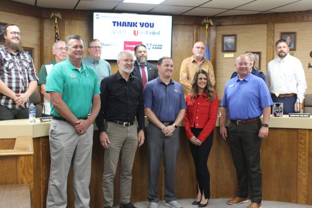 Representatives from five Shawnee Banking Partners pose with the Shawnee Board of Education and Superintendent Dr. Aaron Espolt during the regular meeting on Nov. 6. It was through a lease purchase agreement with the banks and donations from other organizations that the "Turf Project" at Jim Thorpe Stadium was made possible, after approval at the meeting.
