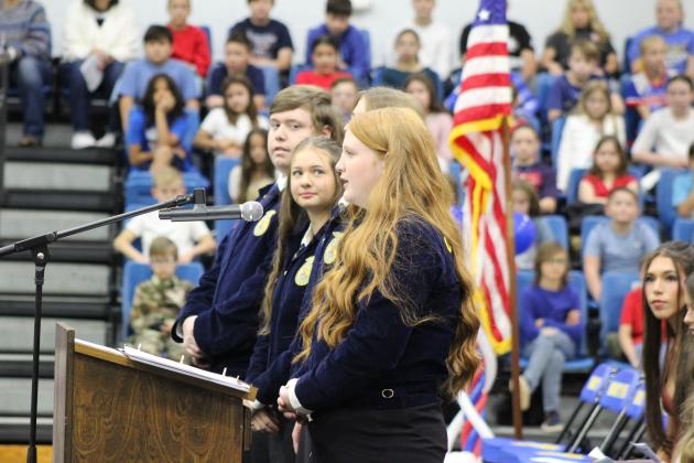 Bethel FFA Historian Sydney Murray recites part of the "Old, Rugged Flag" poem, along with others on the Officer Team, at the Bethel High School Veterans Day Program, Nov. 10. Countywide &amp; Sun/Natasha Dunagan