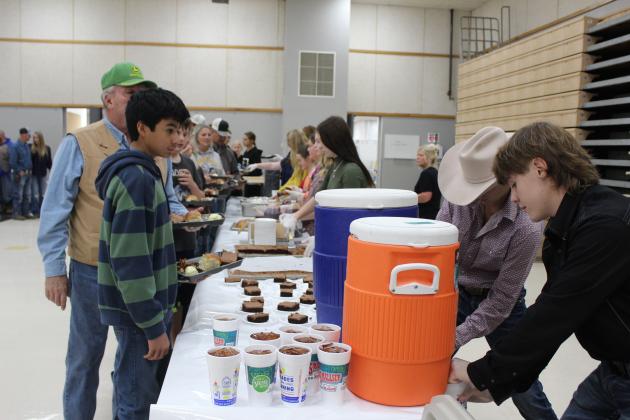 Tecumseh FFA members Bo Spears and Lawson Bordeaux fill cups with sweet and un-sweet tea and serve a fellow FFA student during the Tecumseh High School FFA Pig Roast on Nov. 17. It was estimated by FFA Advisor Mara Carman that around 300 people attended this year's event. Countywide &amp; Sun/Natasha Dunagan