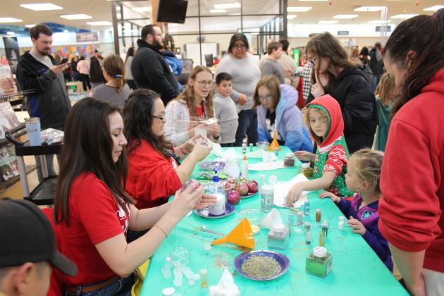 Shawnee Pioneer Library employees Noelani Sogata and Cecilia Young, and library volunteer Natalie Bright help children to decorate clear plastic ornaments during the Shawnee Tree Lighting event on Nov. 17. Besides two types of ornaments to decorate, kids could create something in the Maker Lab, build gingerbread houses and visit with Santa Claus. The elementary school choirs also sang at the Celebration of Life Park before the Christmas tree was lit on top of the library. Countywide &amp; Sun/Natasha Dunagan