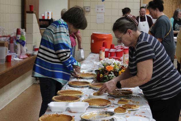 Ronnye Sharp and Linda Bowles slice pumpkin pies and place them on plates or in containers during the 18th Annual Tecumseh Family Thanksgiving Dinner at Tecumseh City Hall Auditorium on Nov. 23. Event organizer Suzanne Gilbert said they gave out 625 to-go dinners and 500 dine-in meals for a total of 1,125 this year. Countywide &amp; Sun/Natasha Dunagan