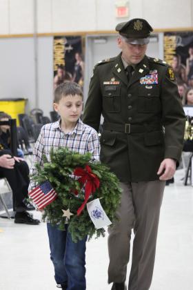 Colonel Lukas Toth and his son, Gavin, carry a wreath to place for the U.S. Coast Guard fallen soldiers during the National Wreaths Across America Day event, Dec. 16, at the W.P. Wood/THS Alumni Center. Toth is a Coast Guard veteran and Army ROTC teacher at the University of Central Oklahoma. Countywide &amp; Sun/Natasha Dunagan