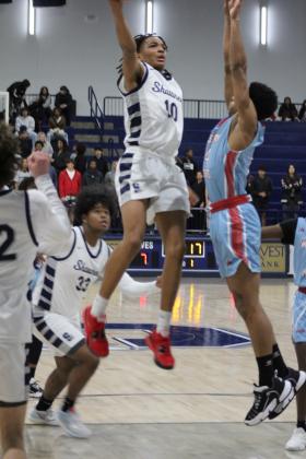 Shawnee sophomore Zyron Campbell shoots for two during the Dec. 12 game against Western Heights. The Wolves won, 86-58, and the Lady Wolves won, as well, 60-8, earlier that night. The Shawnee basketball teams have returned to playing at the newly-repaired Performing Arts and Athletic Center (PAAC). Countywide &amp; Sun/Natasha Dunagan