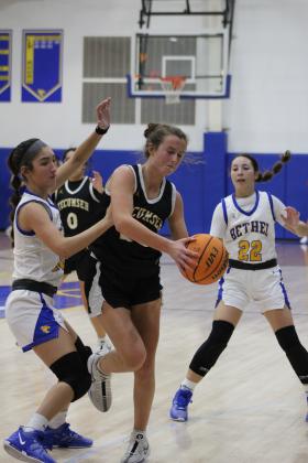 Tecumseh's Emily Gage guards the ball against Bethel's Layla Menhusen and Ava Gascon (#22) before passing in the First United Basketball Classic Girls Finals, held at Bethel High School on Dec. 9. The Lady Savages won all three of their games at the three-day tournament with Perkins-Tryon and Sallisaw, and finally, the Lady Wildcats, 55-46. Countywide &amp; Sun/Natasha Dunagan