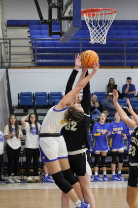 Bethel's Lexi Tucker bends over backwards to try for a basket, as she is guarded by Tecumseh's Reagan Berry, in the First United Basketball Classic Girls Finals against Tecumseh, held at Bethel High School on Dec. 9. The Lady Wildcats won their first two games with Mt. St. Mary and McLoud, then lost to the Lady Savages, 46-55, taking the second-place trophy. Countywide &amp; Sun/Natasha Dunagan