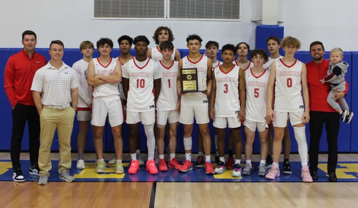 The McLoud Redskins basketball team and their coaches pose with the First United Basketball Classic third-place trophy at Bethel High School on Dec. 9. Over the three-day tournament, they beat Sallisaw, lost to Perkins-Tryon, and won the Consolation Round with Tecumseh, 60-39. Countywide &amp; Sun/Natasha Dunagan