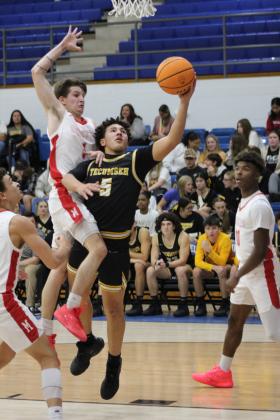 After stealing the ball, Tecumseh's Aveon Stokes aims for the basket and is fouled by McLoud's Bryce Cowns in the Consolation Round of the First United Basketball Classic, held on Dec. 9 at Bethel High School. McLoud won, 60-39, for the third-place trophy. Countywide &amp; Sun/Natasha Dunagan