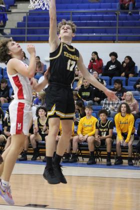 Tecumseh's Kohen Warden tries for two points in the Consolation Round of the First United Basketball Classic against McLoud, held on Dec. 9 at Bethel High School. McLoud won, 60-39, for the third-place trophy. Countywide &amp; Sun/Natasha Dunagan