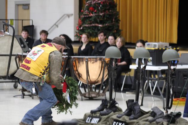 A member of the Oklahoma Gypsy Motorcycle Club places a wreath for U.S. Army fallen soldiers at the National Wreaths Across America Day event, Dec. 16, at the W.P. Wood/THS Alumni Center. Countywide &amp; Sun/Natasha Dunagan