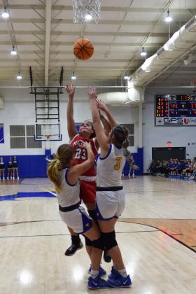 Mcloud's Ali Martinez fouls Bethel's Brooklyn Duff as she shoots for two during the First United Basketball Classic tournament last Friday night.  Bethel won, and then lost to Tecumseh in the Championship game the following night.  Countywide/Sun Julie Talton