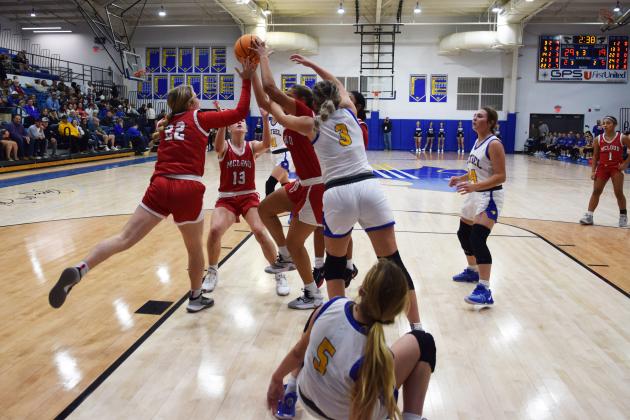 Bethel and Mcloud fight for the rebound during the First United Basketball Classic tournament at Bethel last Friday night.  Bethel won, and then lost to Tecumseh in the Championship game the following night.  Countywide/Sun Julie Talton