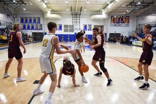Tecumseh's Aveon Stokes lunges over a Blanchard player during the First United Basketball Classic tournament against Blanchard last Friday night.  Countywide/Sun Julie Talton