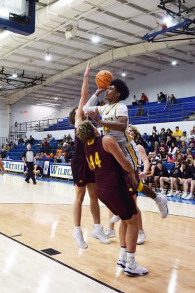 Tecumseh's Jace Edwards gets fouled as he shoots for two during the First United Basketball Classic tournament against Blanchard last Friday night.  Countywide/Sun Julie Talton