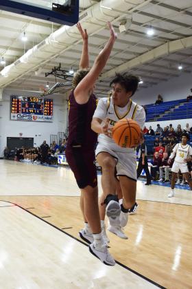 Tecumseh's Jackson Martin passes the ball during the First United Basketball Classic tournament against Blanchard last Friday night.  Countywide/Sun Julie Talton