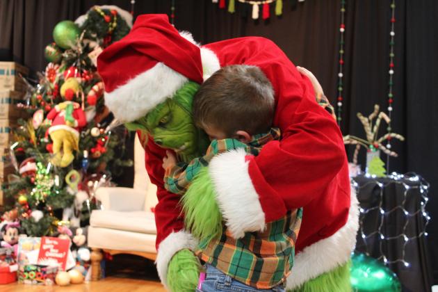 Princetyn Mack, 5, of Shawnee, gets a hug from the Grinch  at the Grinchmas Whoville event, held in the Tecumseh City Hall Auditorium on Nov. 30. Countywide &amp; Sun/Natasha Dunagan