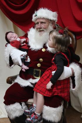 Santa holds GwendoLynn Newhoff, one month old, and KaMaya Napier, 3, both of Shawnee, during the Grinchmas Whoville event, held in the Tecumseh City Hall Auditorium on Nov. 30. Both "Selfies with Santa" and the Grinch photos were sponsored by the Tecumseh Pioneer Library. Countywide &amp; Sun/Natasha Dunagan