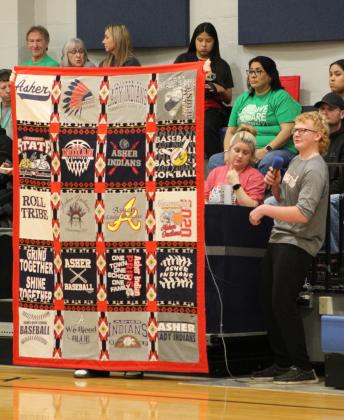 Asher basketball manager Bryson Gregg announces a quilt raffle during halftime of the girls game on Jan. 2. The Asher Indians and Lady Indians T-Shirt quilt was made by Glennie Sanford and will benefit the Asher High School basketball program. The drawing will be held during homecoming. Countywide &amp; Sun/Natasha Dunagan
