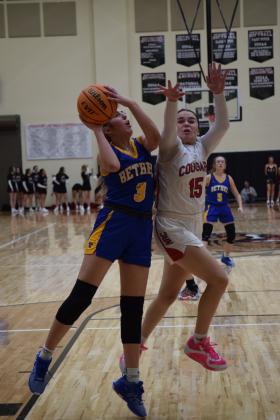 Bethel's Alexis Tucker shoots for two while NRC's Morgan Campbell tries to block her. The Cougars won the battle 51-50. Countywide &amp; Sun/Julie Talton