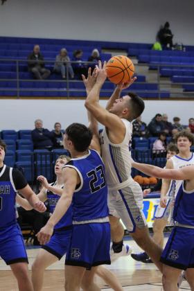 Bethel senior Bray Bussell is fouled as he tries for a basket during the home game with Harrah on Jan. 9.  The Wildcats won, 48-42. Countywide &amp; Sun/Natasha Dunagan