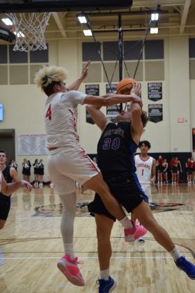 NRC's JJ McClain fouls Bethel's Cale Duncan as he heads for the basket. The Cougars won the battle 68-57 on January 12th. Countywide &amp; Sun/Julie Talton