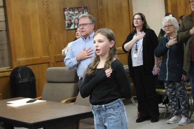 Will Rogers student Elinor Crane leads the Flag Salute.