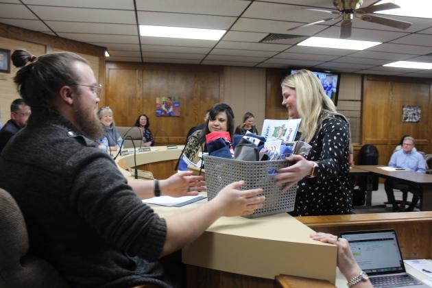 Presenting gift baskets to the school board.