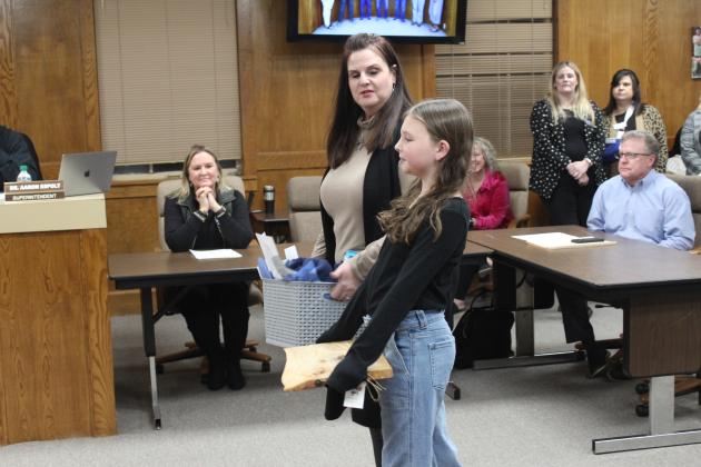 Will Rogers Principal Molly Wilson introduces fifth-grader Elinor Crane.