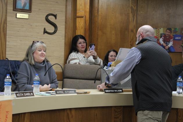 Presenting gift baskets to the school board.