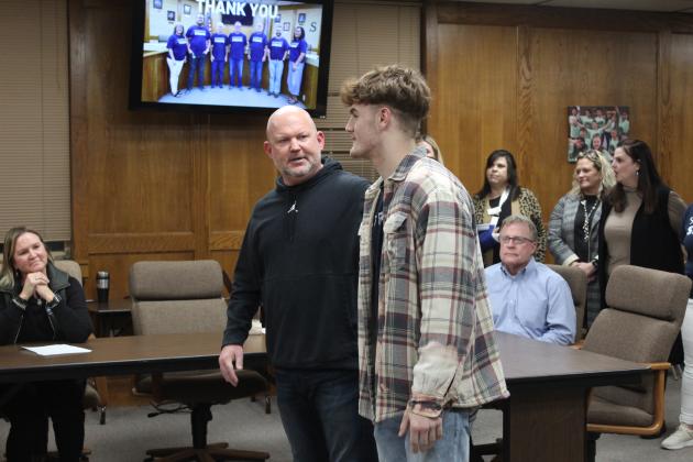 SHS student Ryan High thanks the school board, as AD Dax Leone listens.