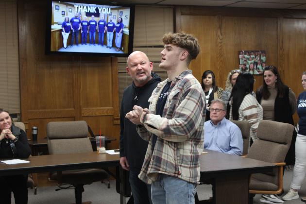 SHS student Ryan High thanks the school board, as AD Dax Leone listens.