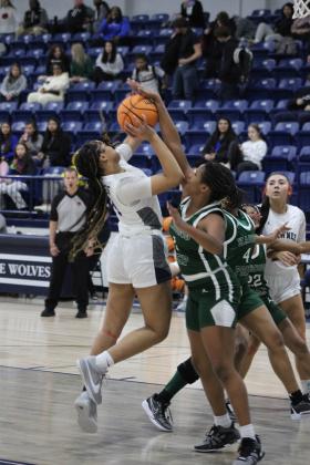 Shawnee freshman Chrishelle Milum goes to the hoop, but draws a foul during their first game of the Lowe's/Firelake Arena Shawnee Invitational on Jan. 18. The Lady Wolves beat Harding Prep, 40-21; lost to Class 6A Yukon, 33-44, on Jan. 19; and toppled Coweta, 45-33, Jan. 20, to take third place in the tournament. Countywide &amp; Sun/Natasha Dunagan