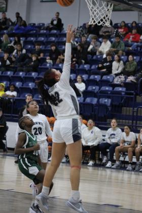 Shawnee junior Serenity Casteel gets an assist from senior Tylyn Thurman and makes two points during their first game of the Lowe's/Firelake Arena Shawnee Invitational on Jan. 18. The Lady Wolves beat Harding Prep, 40-21; lost to Class 6A Yukon, 33-44, on Jan. 19; and toppled Coweta, 45-33, Jan. 20, to take third place in the tournament. Countywide &amp; Sun/Natasha Dunagan