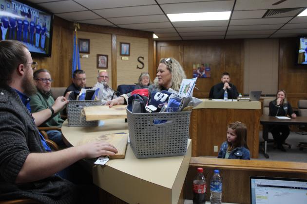Jefferson Elementary Principal Jennifer Epperley and kindergartner Remi Maher present gifts to the Shawnee Board of Education during their Jan. 8 meeting.  Also shown are board members, from left, Turner Bass, Russ Oliver, President Clif Harden, Keith Sandlin and April Stobbe, and Superintendent Dr. Aaron Espolt. January is Board of Education Appreciation Month. Countywide &amp; Sun/Natasha Dunagan