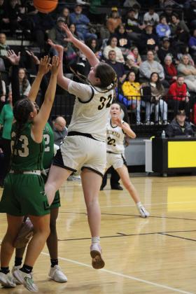 Tecumseh senior Reagan Berry shoots over her shoulder in the first quarter of the Jan. 9 home game with Jones. The Lady Savages lost, 31-41. Countywide &amp; Sun/Natasha Dunagan