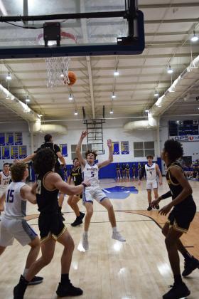 Bethel's Zack Jennings flings the ball into the net as he falls backwards.  Bethel lost the double overtime matchup against Tecumseh on Feb. 2nd 60-64. Countywide &amp; Sun/ Julie Talton