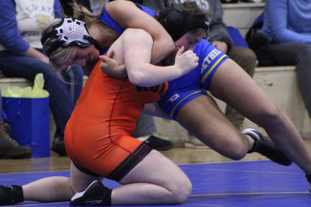 In an exhibition match, Bethel's Caitlyn Harman tries to topple Konawa's Aubrey Ramos during the wrestling meet on Jan. 25. Bethel also faced Prague for the Wrestling Homecoming and Senior Night meet. Countywide &amp; Sun/Natasha Dunagan