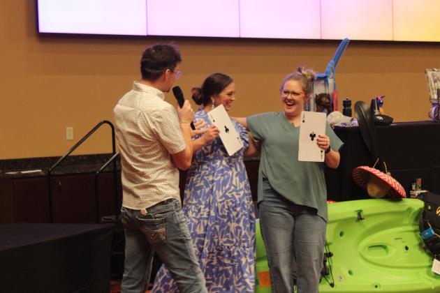 Kortnee Thomas, far right, celebrates with Luke Fugate and Nicole Sanchez after winning the "Lotteria Loca" at the Tecumseh "Cha-Cha" Chamber Auction, held at the Grand Casino Hotel &amp; Resort on Feb. 8. Hers was the last card selected, and she won the kayak package from the live auction. Countywide &amp; Sun/Natasha Dunagan