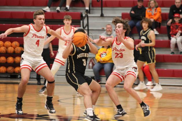 Dale's Jett Higdon (#4), Tray Chambers (#24), and Deken Jones (#23) defend the hoop during the Class 2A District game with Mounds, Feb. 17. The Pirates stomped Mounds, 90-37, and will play in regional competition at Dale today (Feb. 22) at 7:30 pm.  Countywide &amp; Sun/Natasha Dunagan