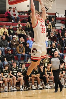 With an assist from his younger brother Denton, Dale senior Dayton Forsythe makes a slam dunk during the Class 2A District game with Mounds, Feb. 17. The Pirates stomped Mounds, 90-37, and will play in regional competition at Dale today (Feb. 22) at 7:30 pm.  Countywide &amp; Sun/Natasha Dunagan