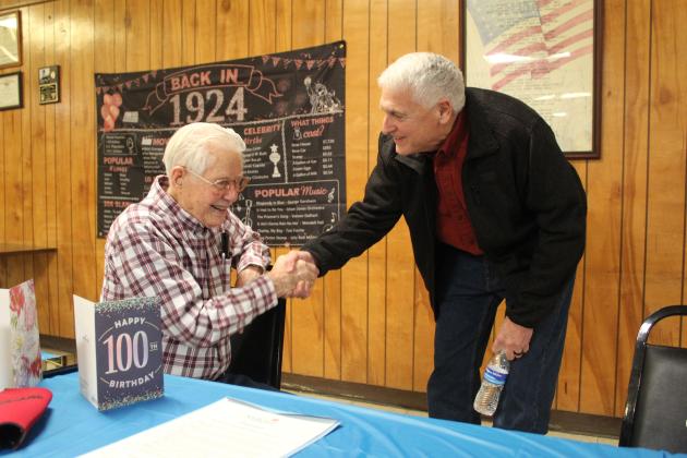 Shawnee Mayor Ed Bolt, right, wishes Noah "Sonny" Hines a happy 100th birthday at the Veterans of Foreign Wars Post 1317, Feb. 5. Hines said he has also had parties at his church and with his fellow "railroaders," and his family and friends will be celebrating at a Shawnee restaurant on Feb. 18. Countywide &amp; Sun/Natasha Dunagan