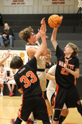 Maud’s Bowdie Brooks goes up for a shot and is fouled by the Wanette defense in the third quarter of the homecoming game on Jan. 26. The Maud Tigers beat the Wanette Tigers, 61 -40. Also shown are Marcus Sims (#33) and Landon Cannon (#23).