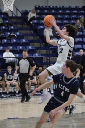 Shawnee freshman Edan Litherland keeps his eye on the goal and makes two points during their last regular season home game, with Altus on Feb. 9. The Wolves won, 73- 56.