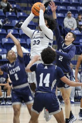 Shawnee sophomore Aidon Siqueiros tries for a jump shot in the home game against Altus.