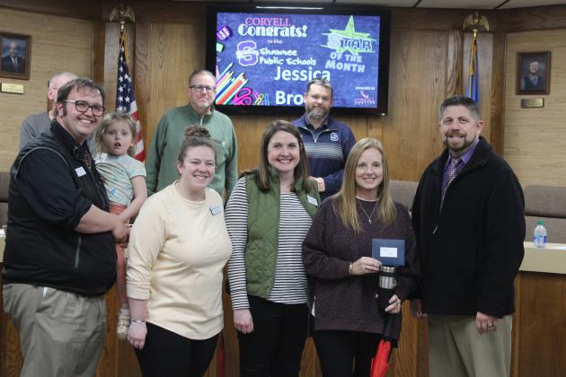 Shawnee Superintendent Dr. Aaron Espolt, far right, presents gifts and a gift card to Shawnee Middle School English Language Arts (ELA) Teacher Jessica Brown, Shawnee's Star of the Month. Also shown, front from left, are SMS Assistant Principal Levi Dobrinski (holding his daughter), Assistant Principal Hannah Holland, Principal Keely Tolin, Brown, Espolt, back from left, board members Bobby Canty (hidden), Russ Oliver and Clif Harden. Countywide &amp; Sun/Natasha Dunagan