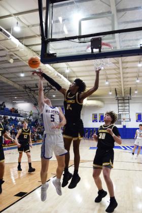 Tecumseh Jase Edwards denies the basket of Zack Jennings in the fight against Bethel on Feb. 2nd.  The Savages took the double overtime win 64-60. Countywide &amp; Sun/Julie Talton
