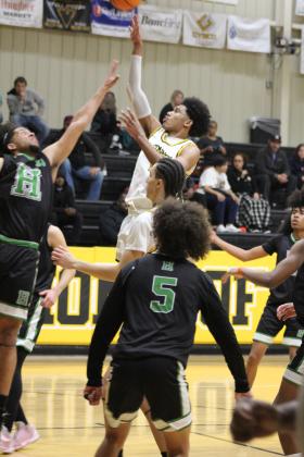 Tecumseh senior Jase Edwards puts up a shot in the third quarter of the Class 4A Distirct game against Harding Charter on Feb. 16. The Savages won, 75-74, and will play in Regional competition today (Feb. 22) in Douglass, along with the Lady Savages who also won Districts. Countywide &amp; Sun/Natasha Dunagan